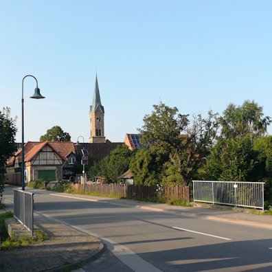A quiet village scene with simple homes and children playing in the street.