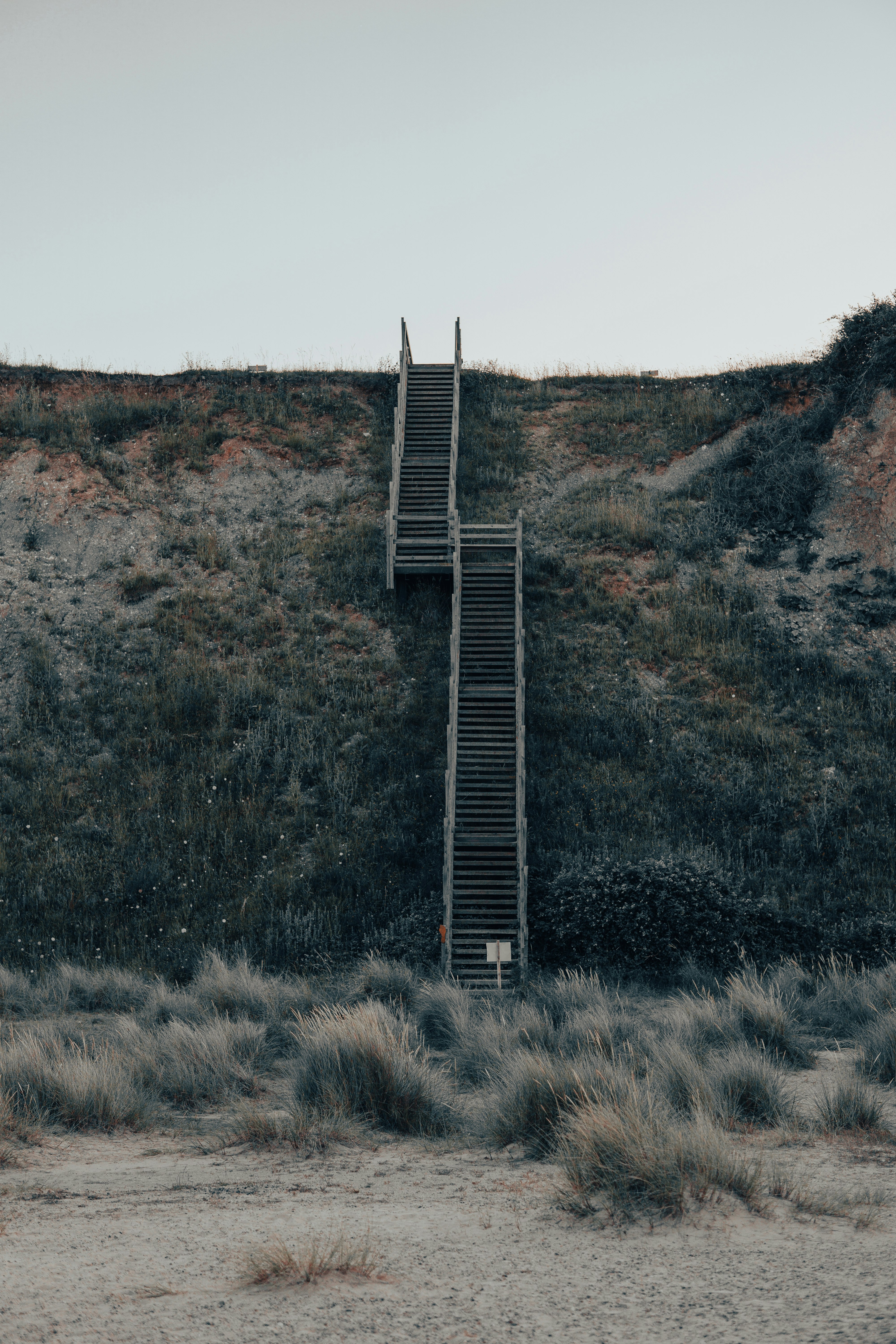 black metal bridge on brown grass field