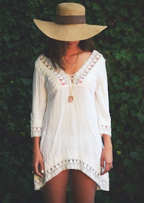 Blurred face of a model showcasing a modest dress with delicate lace details.