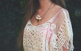 woman in white and red floral shirt wearing silver necklace
