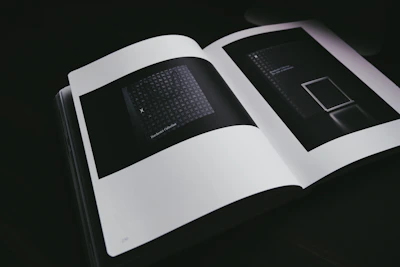 An edgy, modern graphic depicting an open book with surreal elements spiraling out, hinting at fictional worlds.