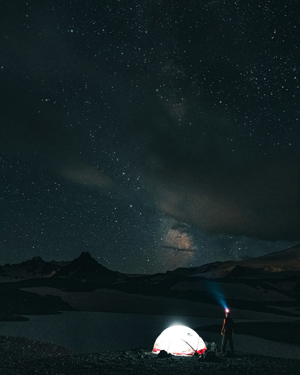 silhouette of mountain under starry night