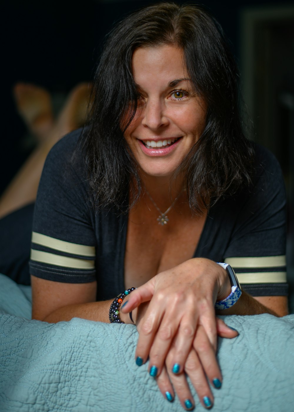 woman in black and white striped shirt smiling