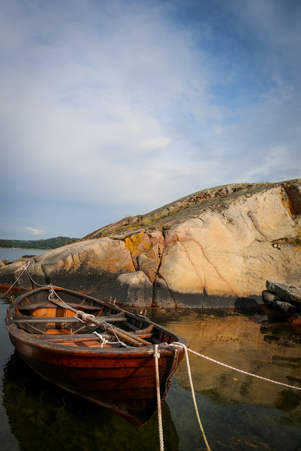brown wooden boat on shore during daytime