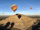 yellow red and blue hot air balloon on brown sand