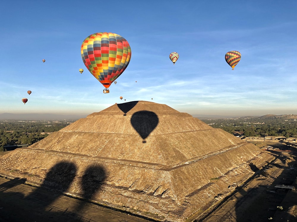 yellow red and blue hot air balloon on brown sand