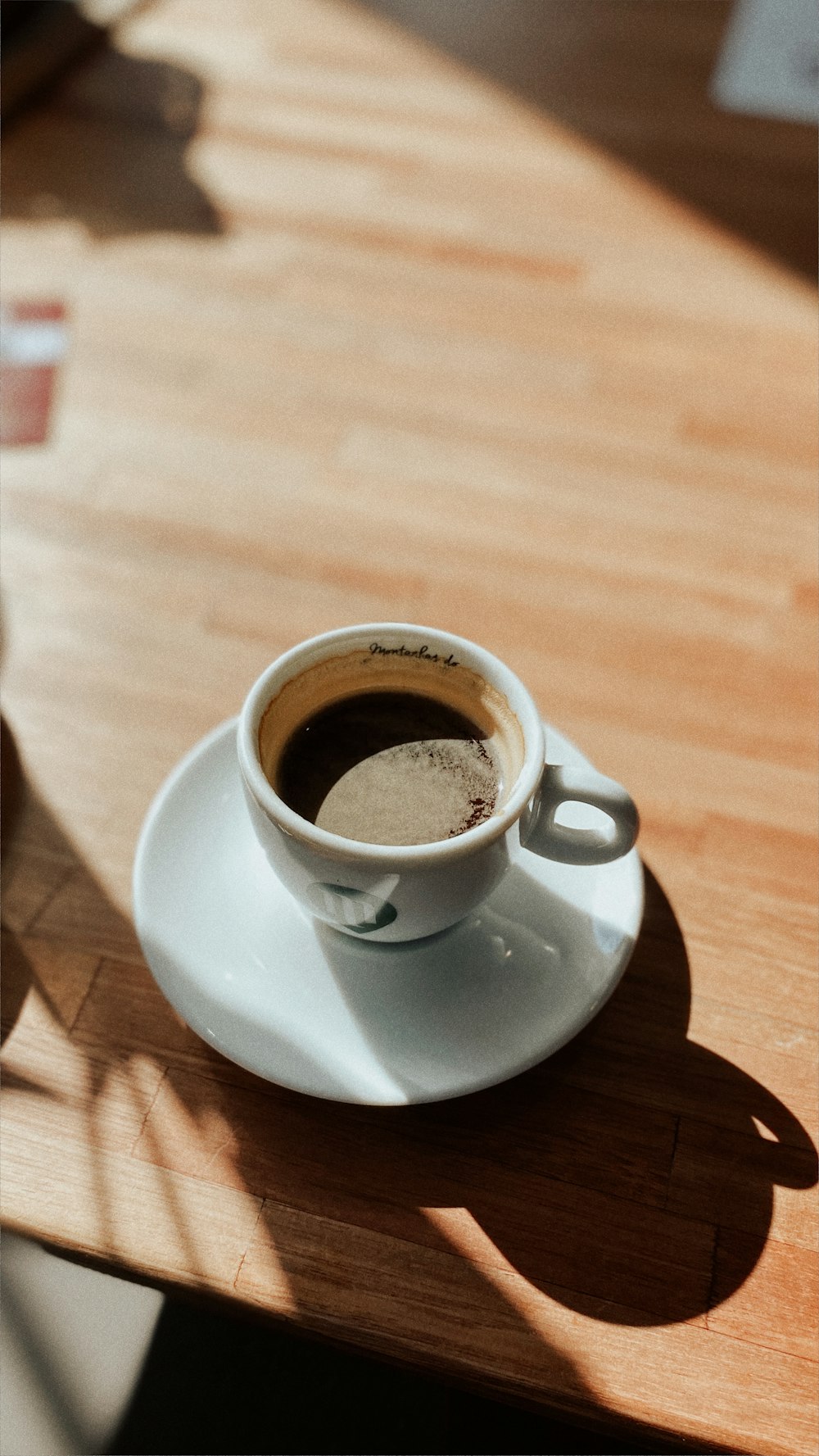 white ceramic cup on white ceramic saucer