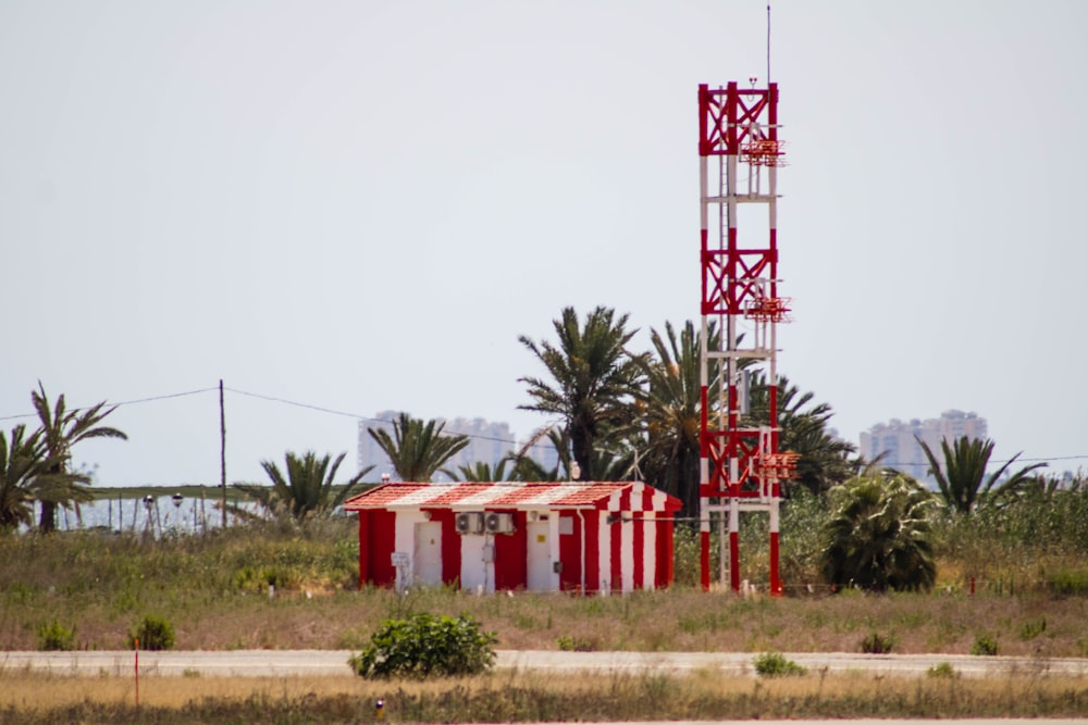 red and white wooden house near green trees during daytime