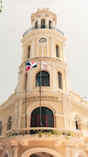 white concrete building with flag on top