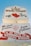 The image displays a sign for 'A Little White Chapel' featuring red hearts and ribbons. The lower section highlights that notable figures have married there, with names like Michael Jordan and Joan Collins. It also promotes a 24-hour drive-up wedding window.