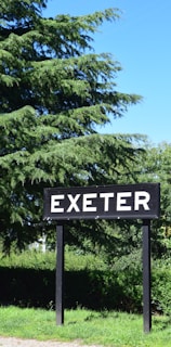 a sign that says exter in front of some trees