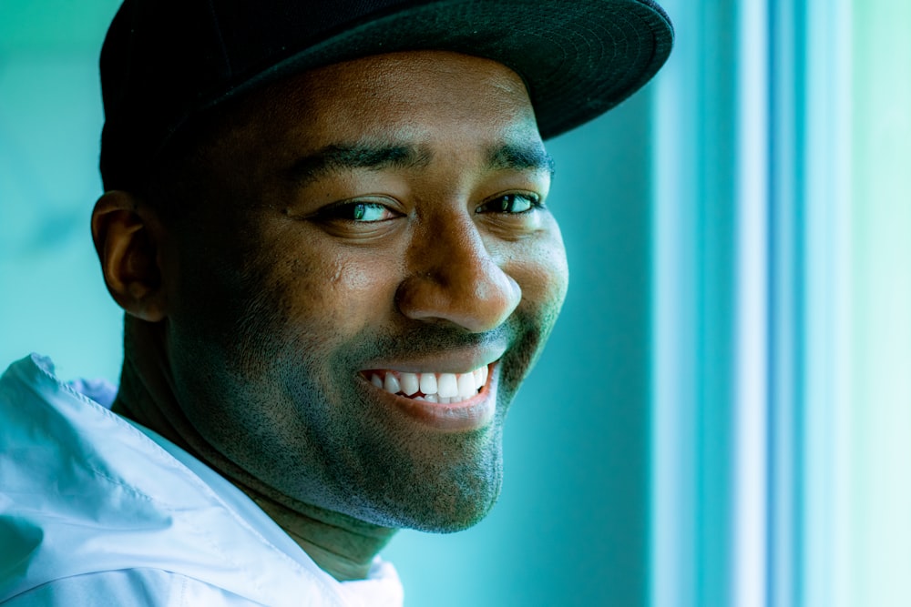 man in white collared shirt wearing black hat