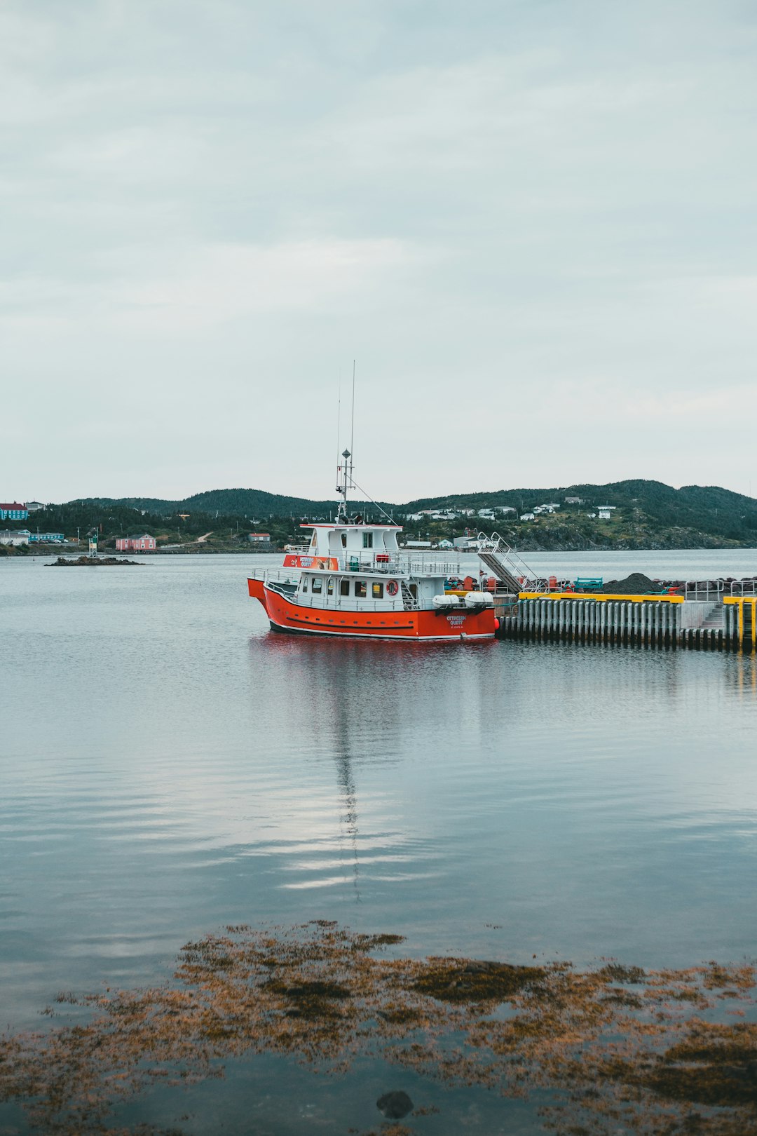 red and white boat on body of water during daytime