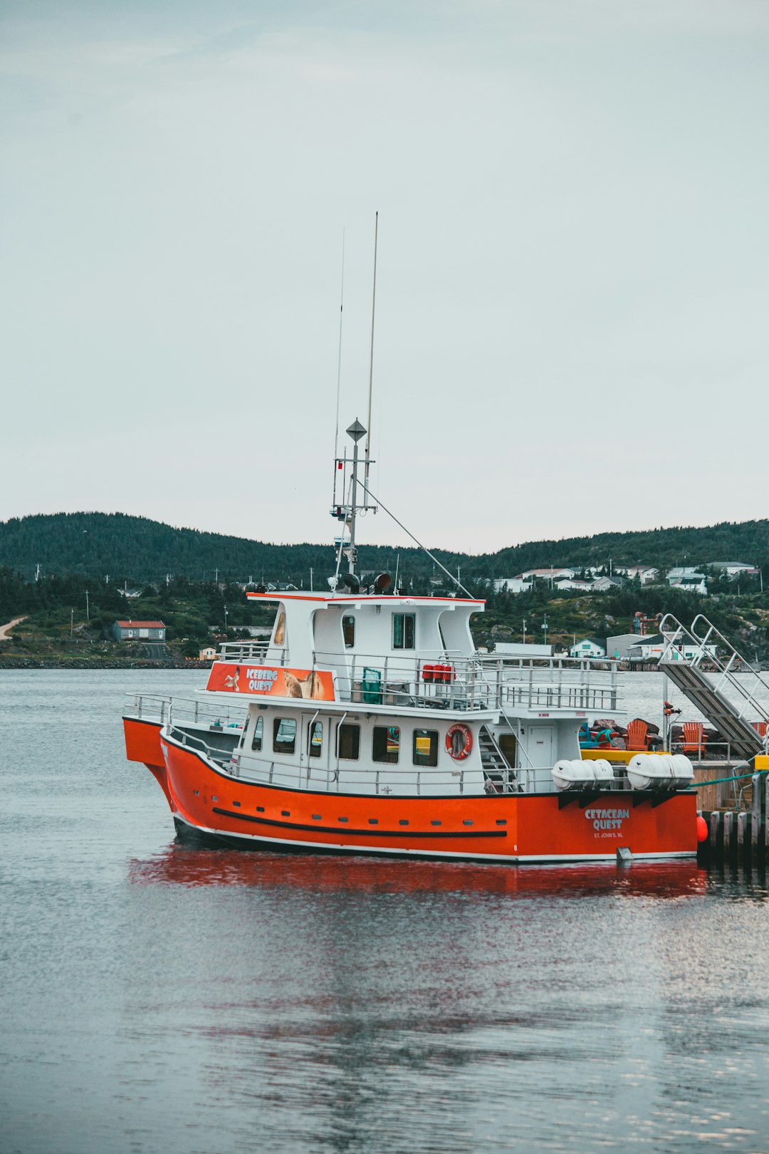 orange and white boat on water during daytime