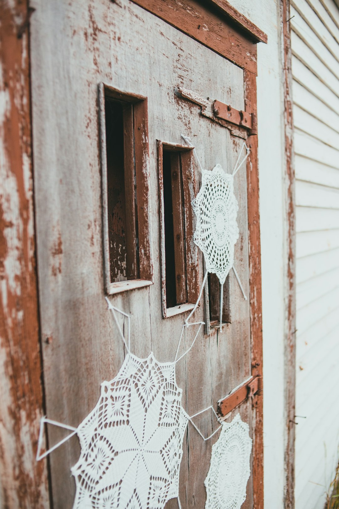 white lace textile on brown wooden window
