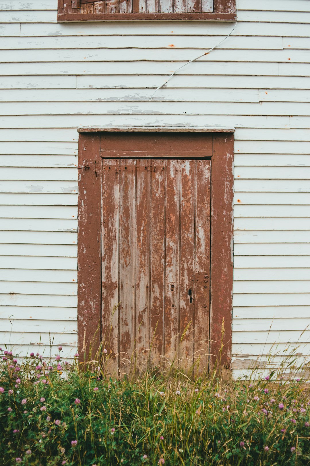 brown wooden door on white wooden wall