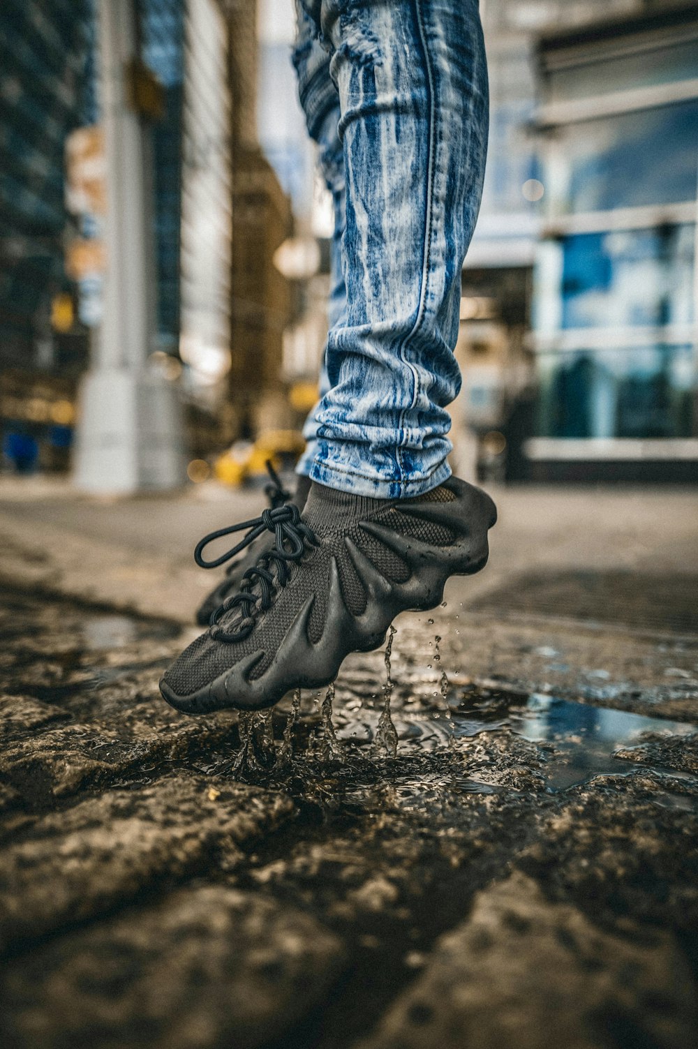 person in blue denim jeans and black nike sneakers