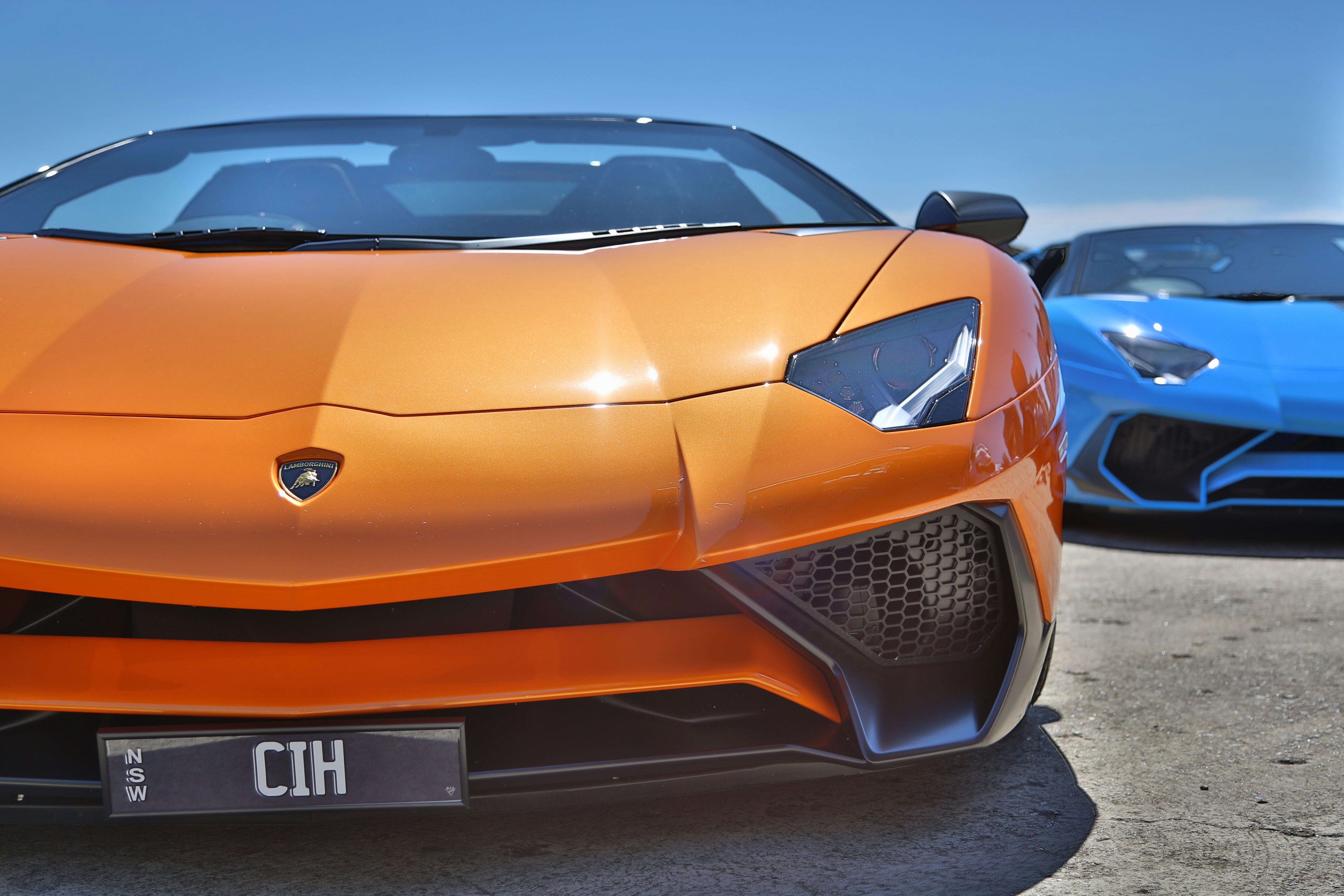 orange lamborghini aventador on road during daytime