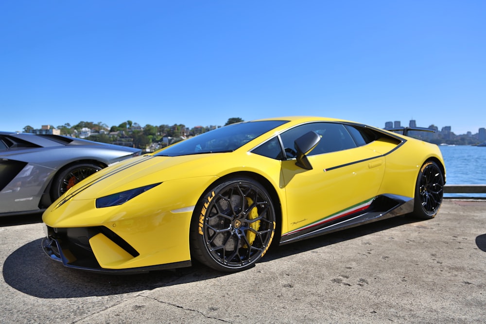 yellow lamborghini aventador on gray asphalt road during daytime