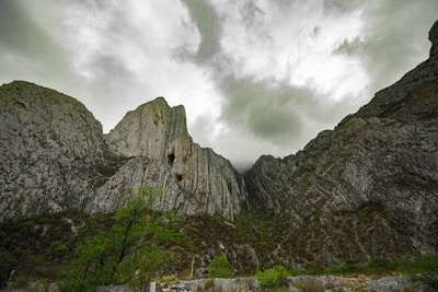 A dramatic shot of rugged alpine cliffs under a moody sky, showcasing Europe’s natural grandeur.