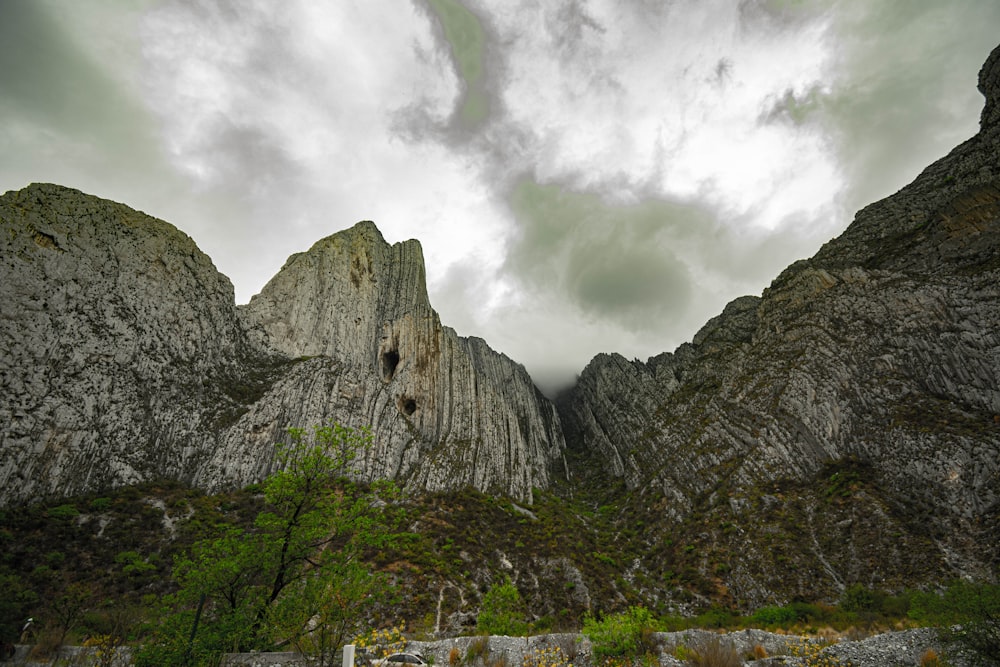 gray rocky mountain under cloudy sky during daytime