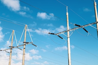 brown electric post under blue sky during daytime