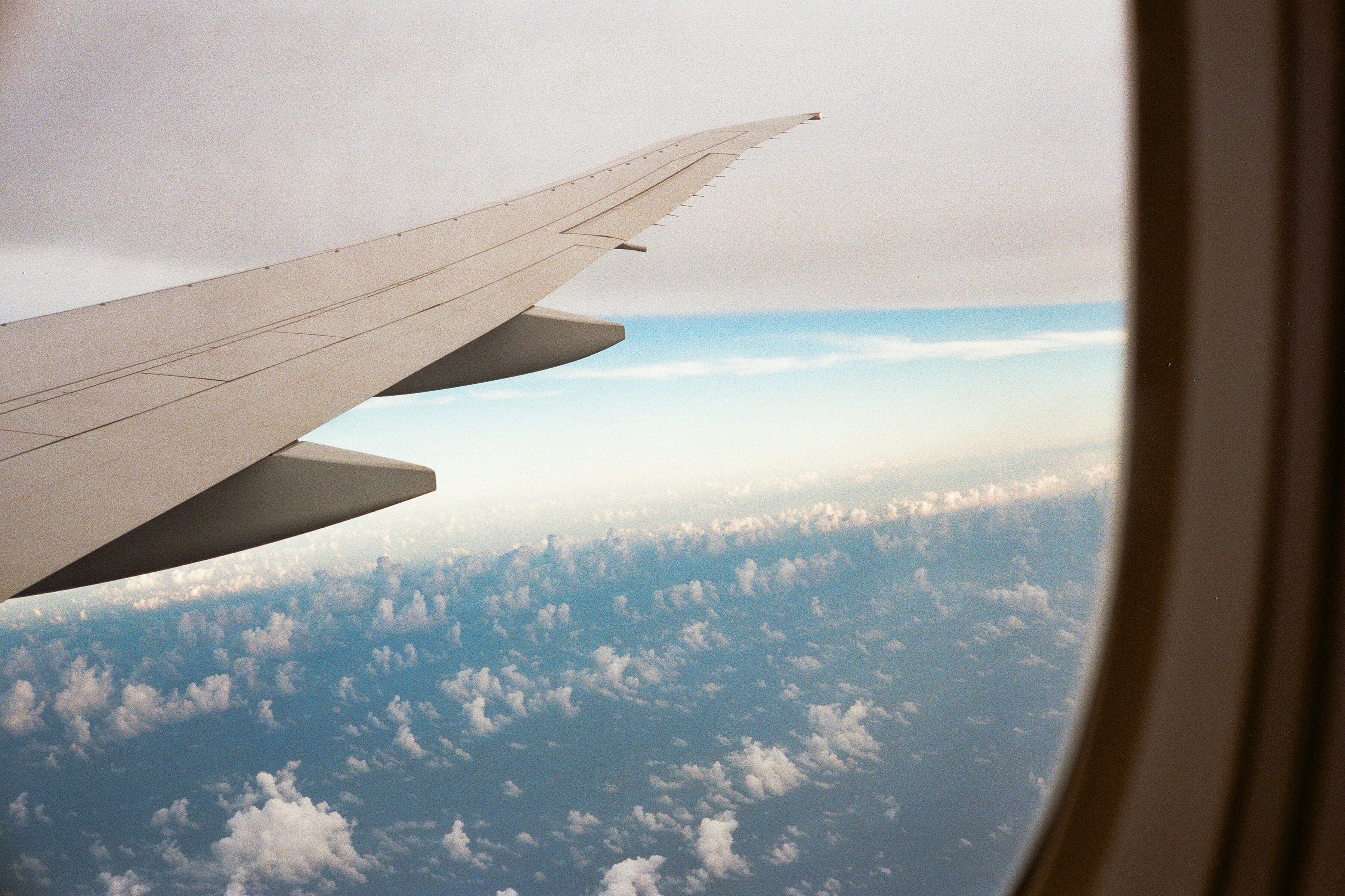 white clouds and blue sky during daytime, view from the airplane window