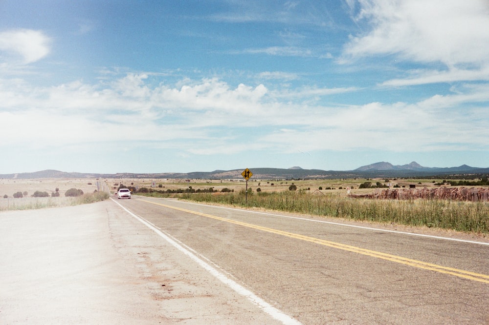 gray asphalt road under blue sky during daytime