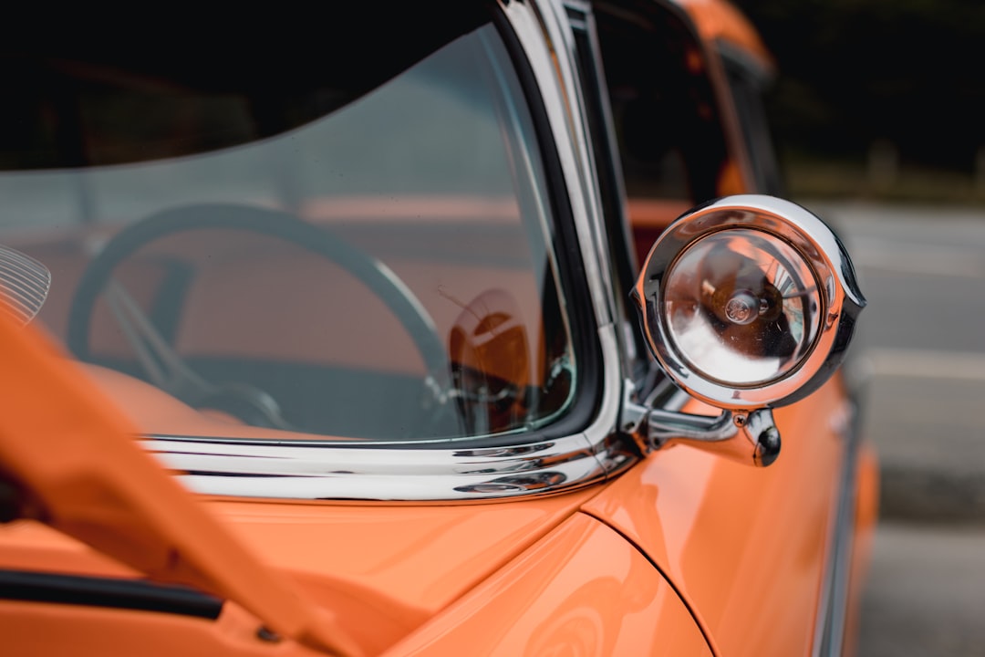 orange car with side mirror