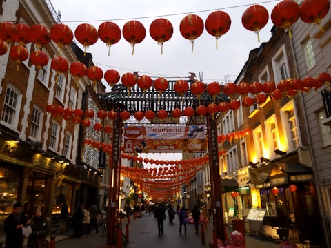 A vibrant street scene decorated with red lanterns and festive banners for Chinese New Year.