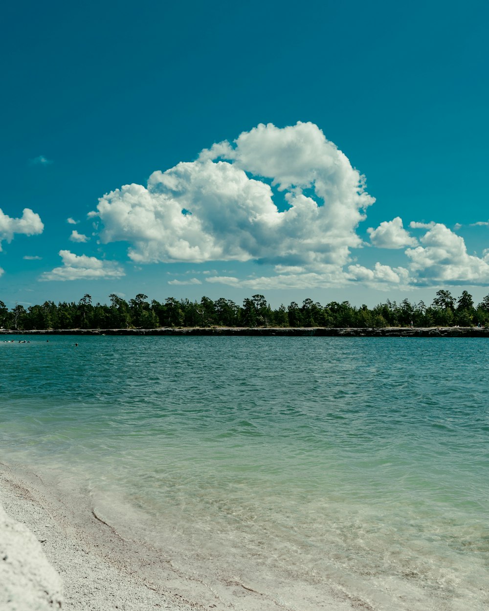 blue sea under blue sky and white clouds during daytime