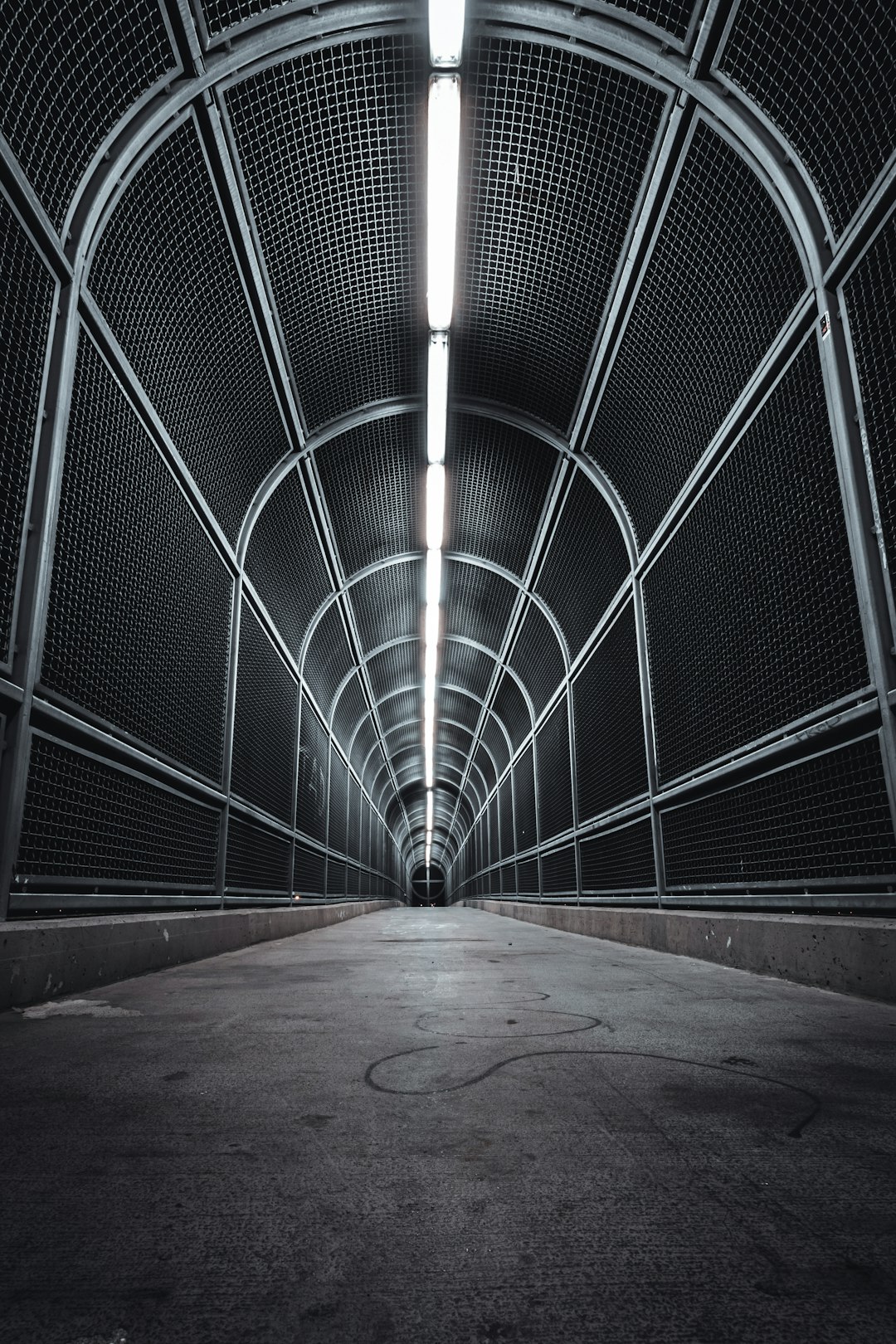 gray concrete hallway with white metal railings