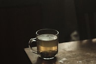 clear glass mug with brown liquid