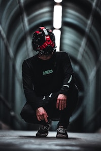 man in black jacket wearing red helmet