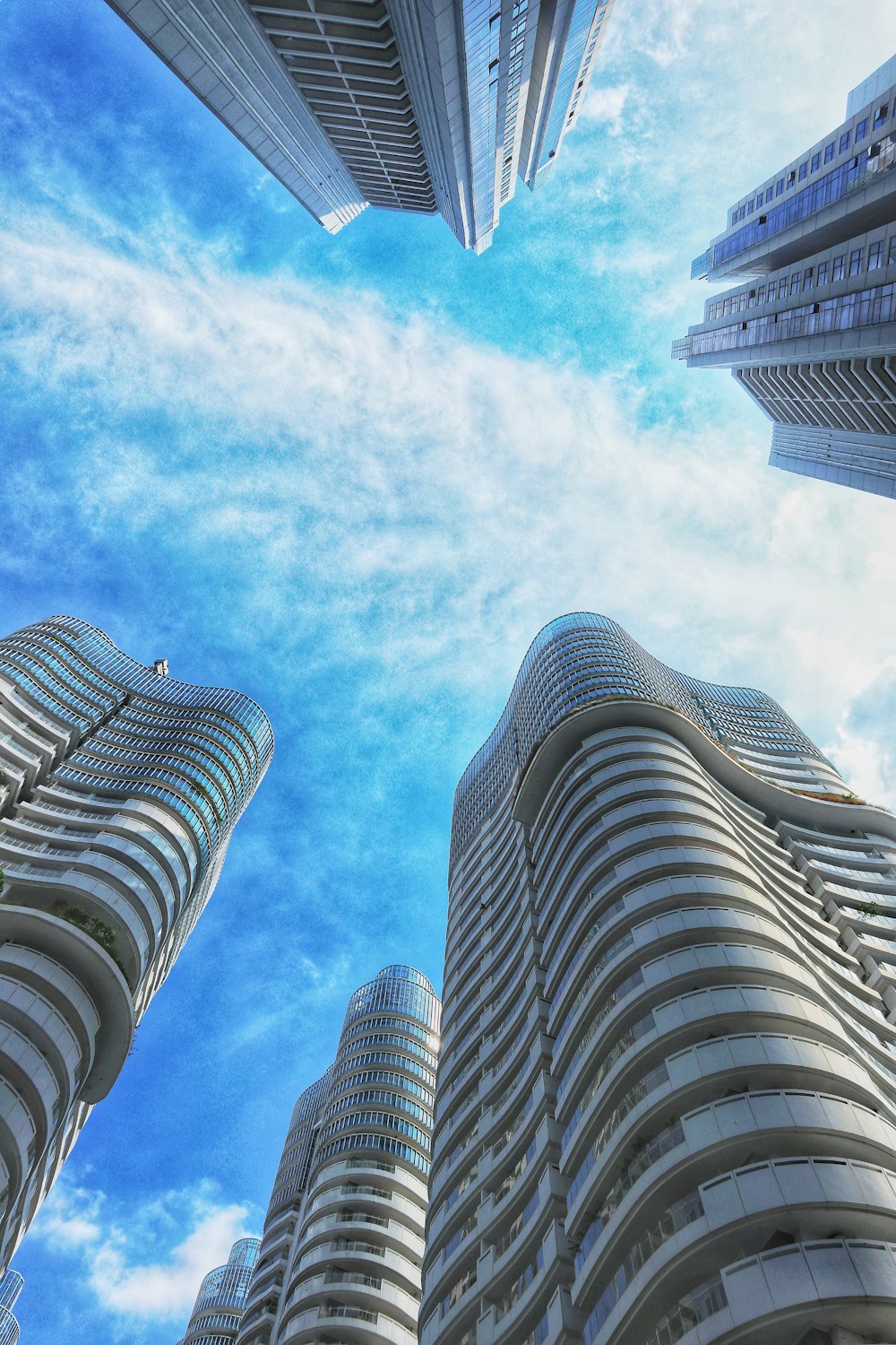 low angle photography of high rise building under blue sky during daytime