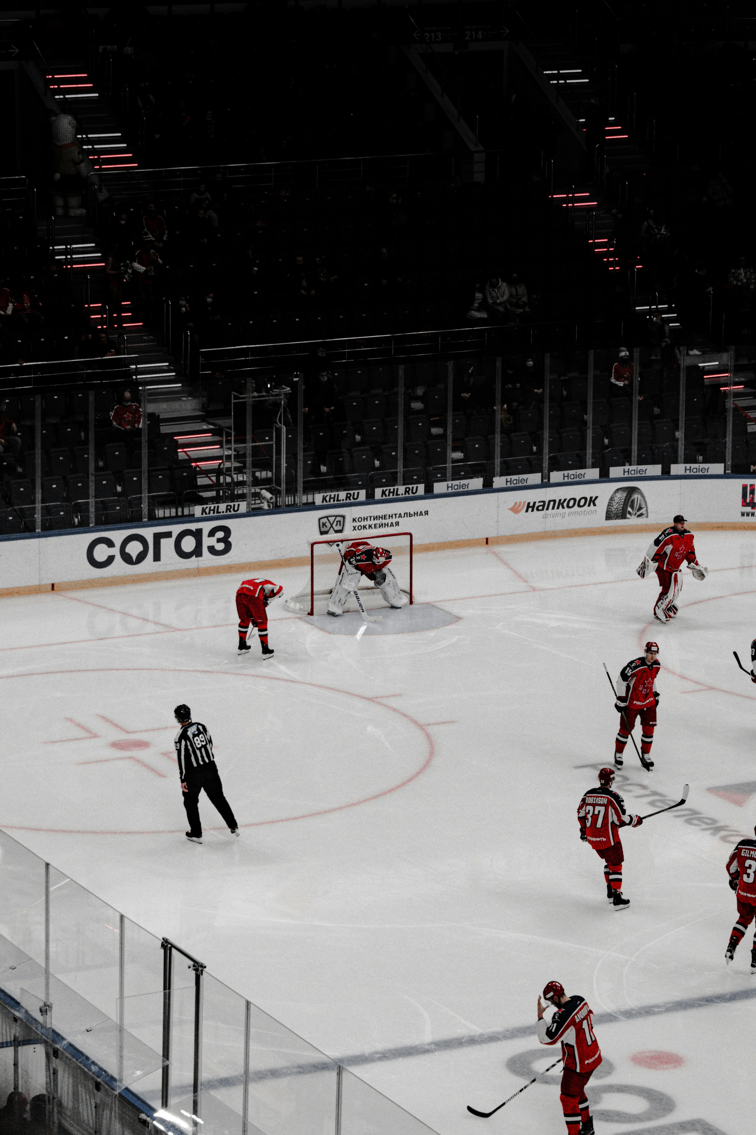 people playing ice hockey on ice stadium