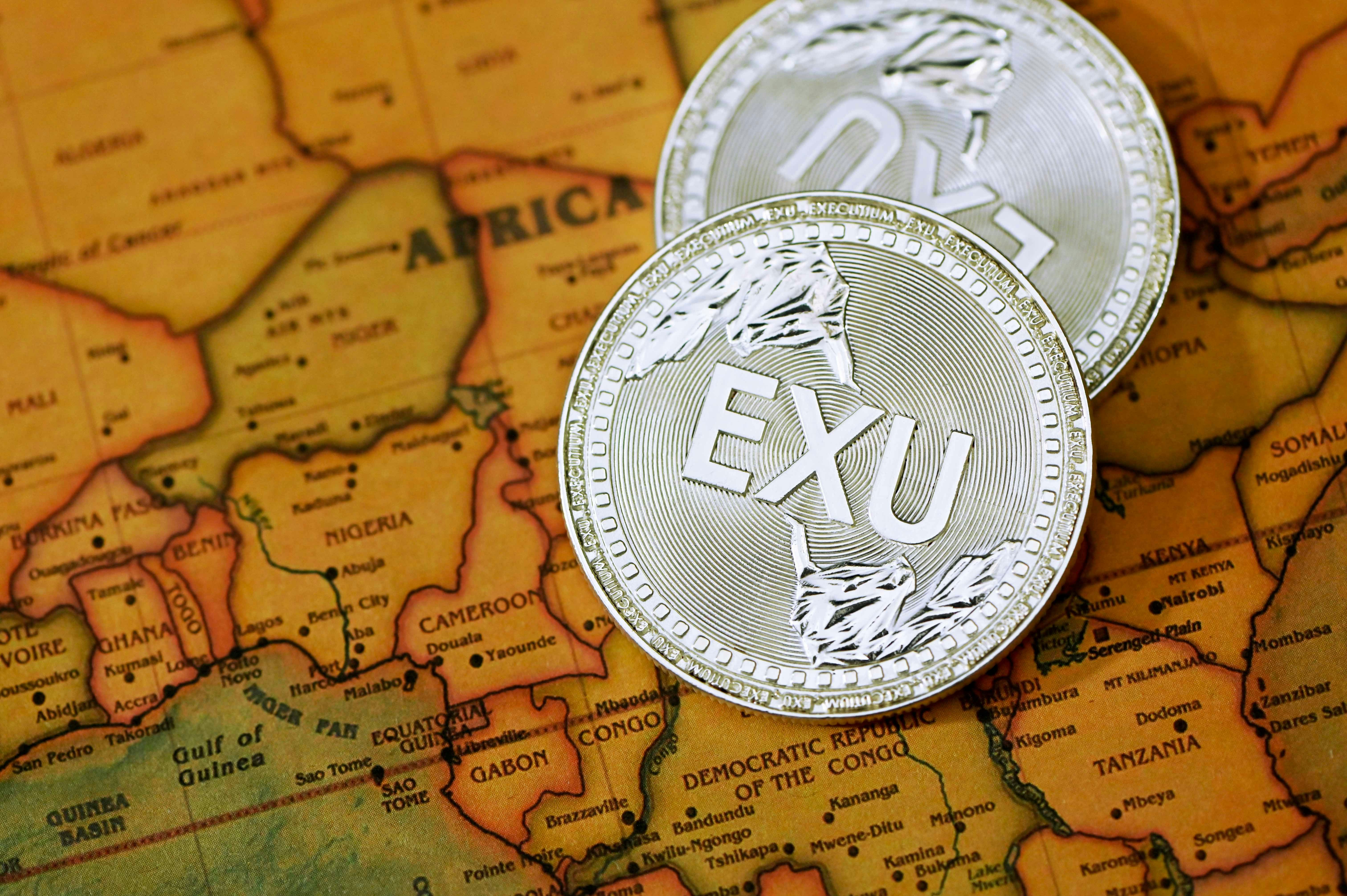 silver round coin on brown textile