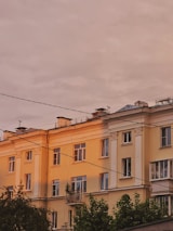 Elegant residential building in Vienna bathed in warm afternoon light.