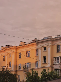 Exterior shot of a residential building in Pinheiros during sunset highlighting architectural details