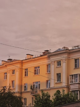 Elegant residential building in Vienna bathed in warm afternoon light.