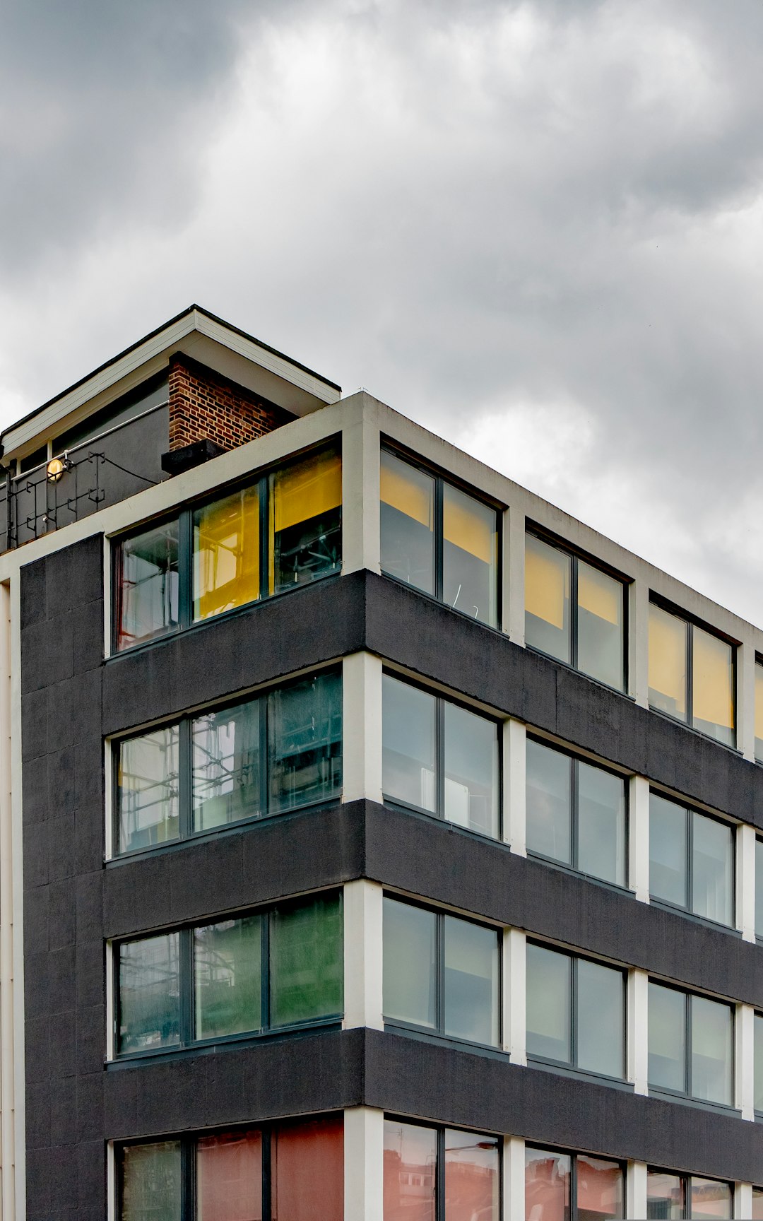 gray concrete building under cloudy sky during daytime