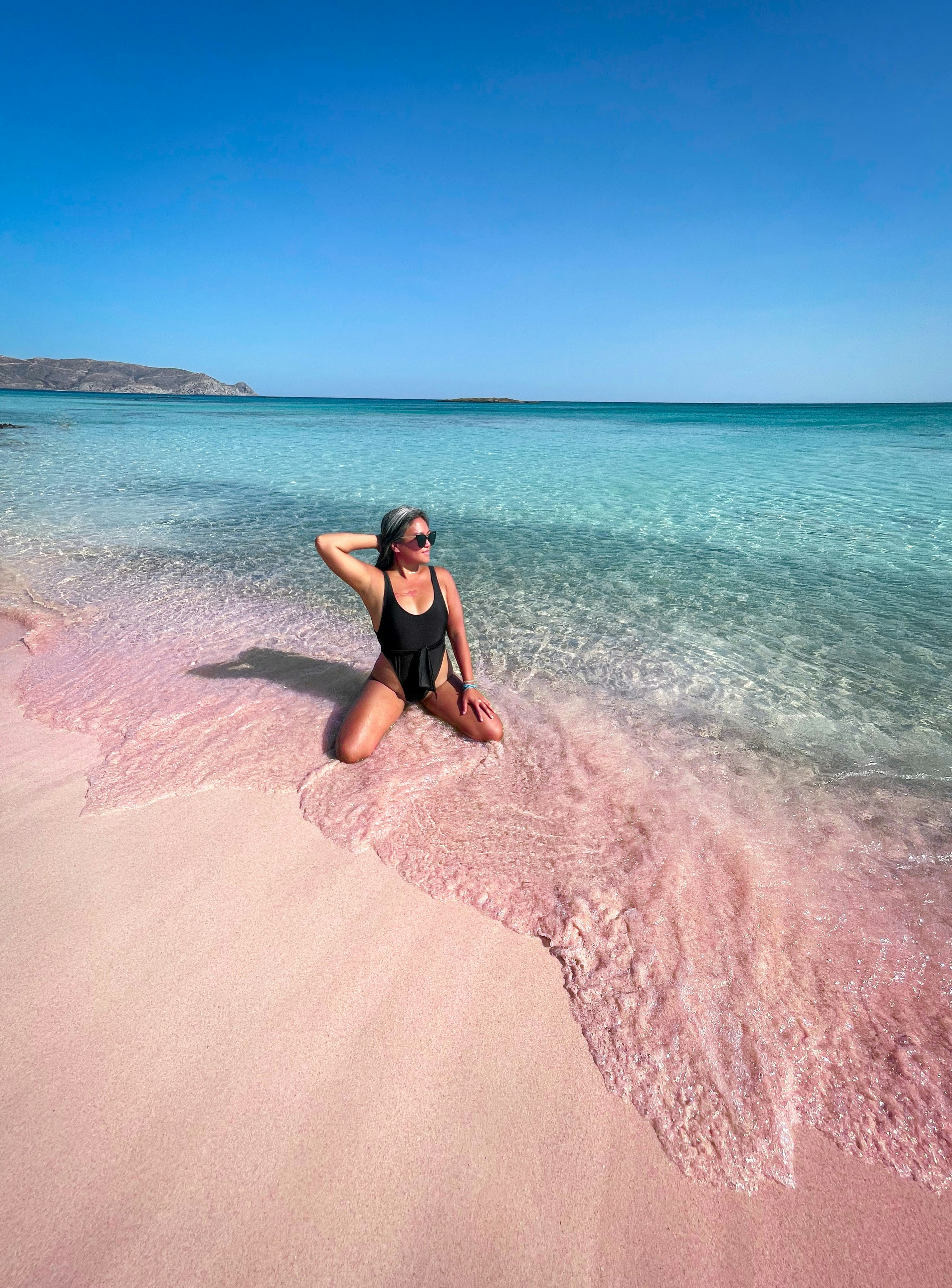 Wearing my Dippin Daisy's swimsuit at Elafonisi Pink Sand Beach in Crete, Greece