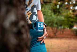 a woman is holding a cell phone in her pocket