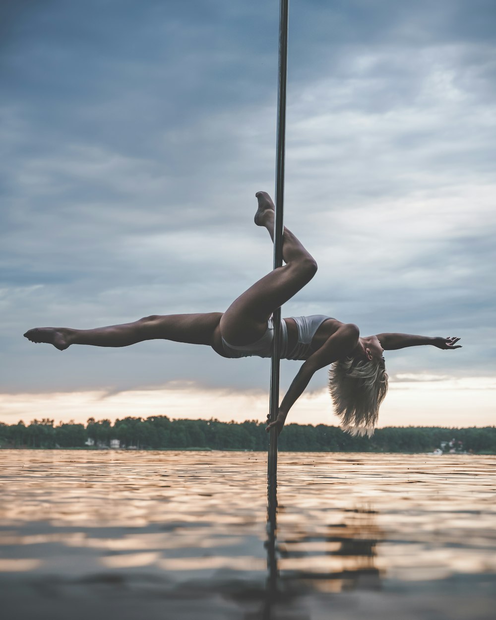 woman in black bikini on black metal pole during daytime