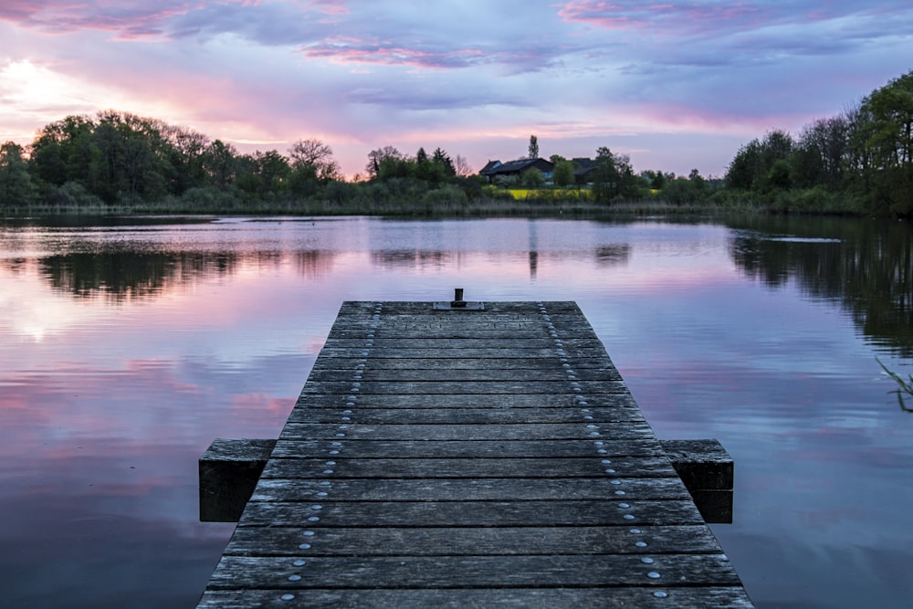 brown wooden dock on lake during daytime