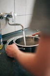 person washing stainless steel bowl