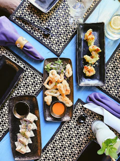 black ceramic tray with food on purple textile