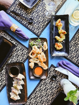 black ceramic tray with food on purple textile