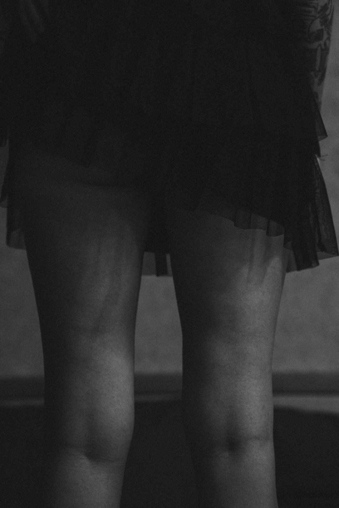 grayscale photo of woman in black skirt