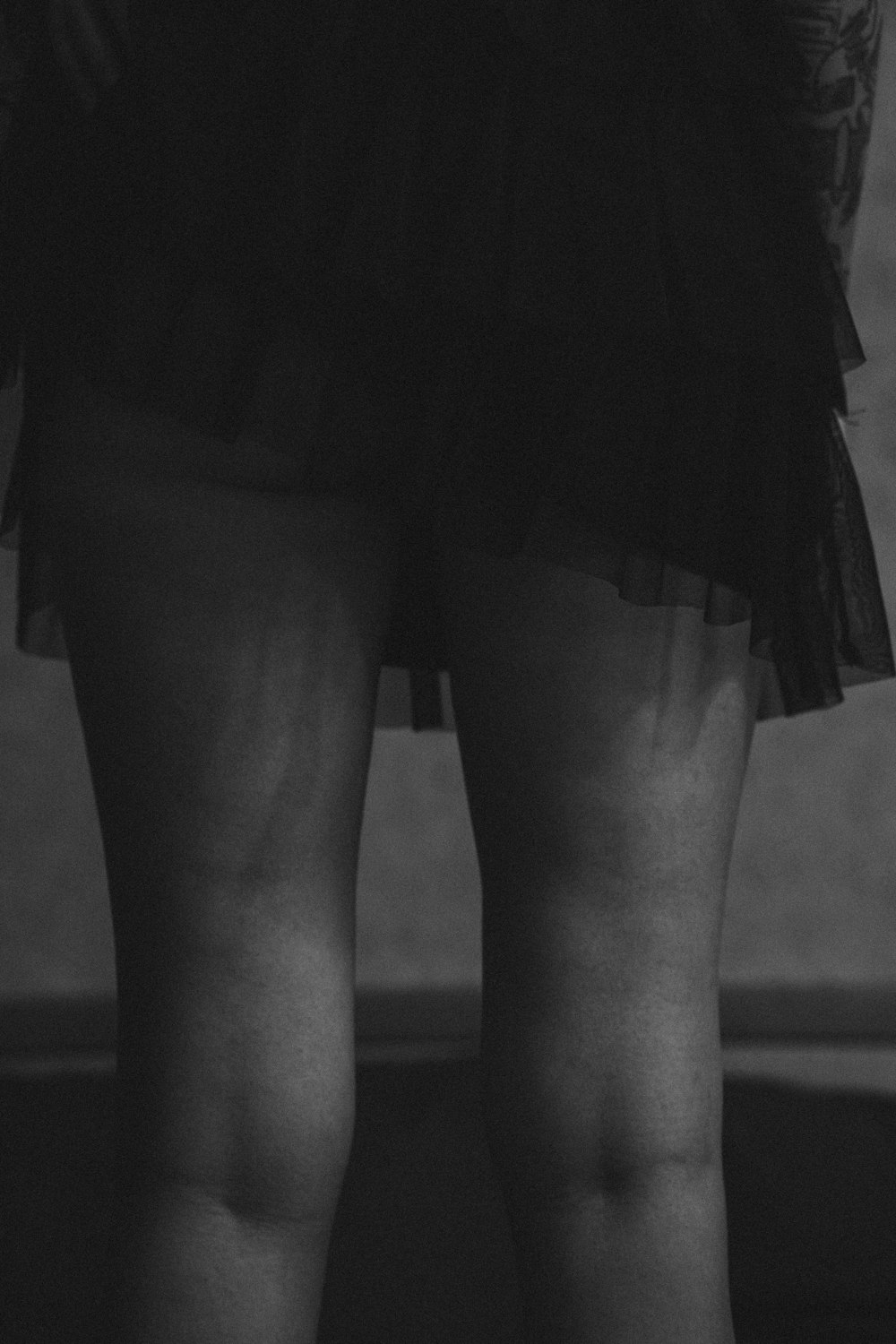 grayscale photo of woman in black skirt